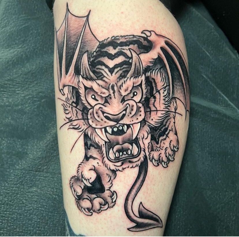 a tattoo of a tiger with horns and wings