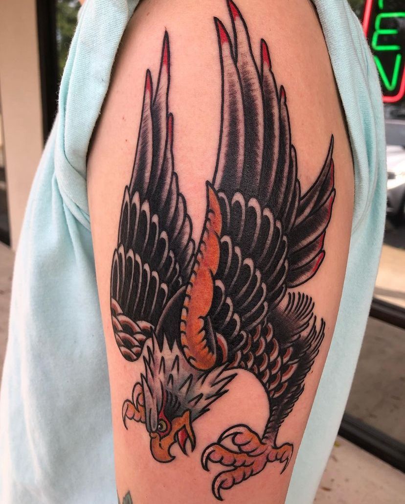 a person has a tattoo of a red flower on their forearm