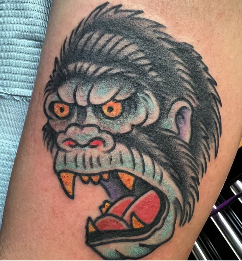 a tattoo of a gorilla with its mouth open