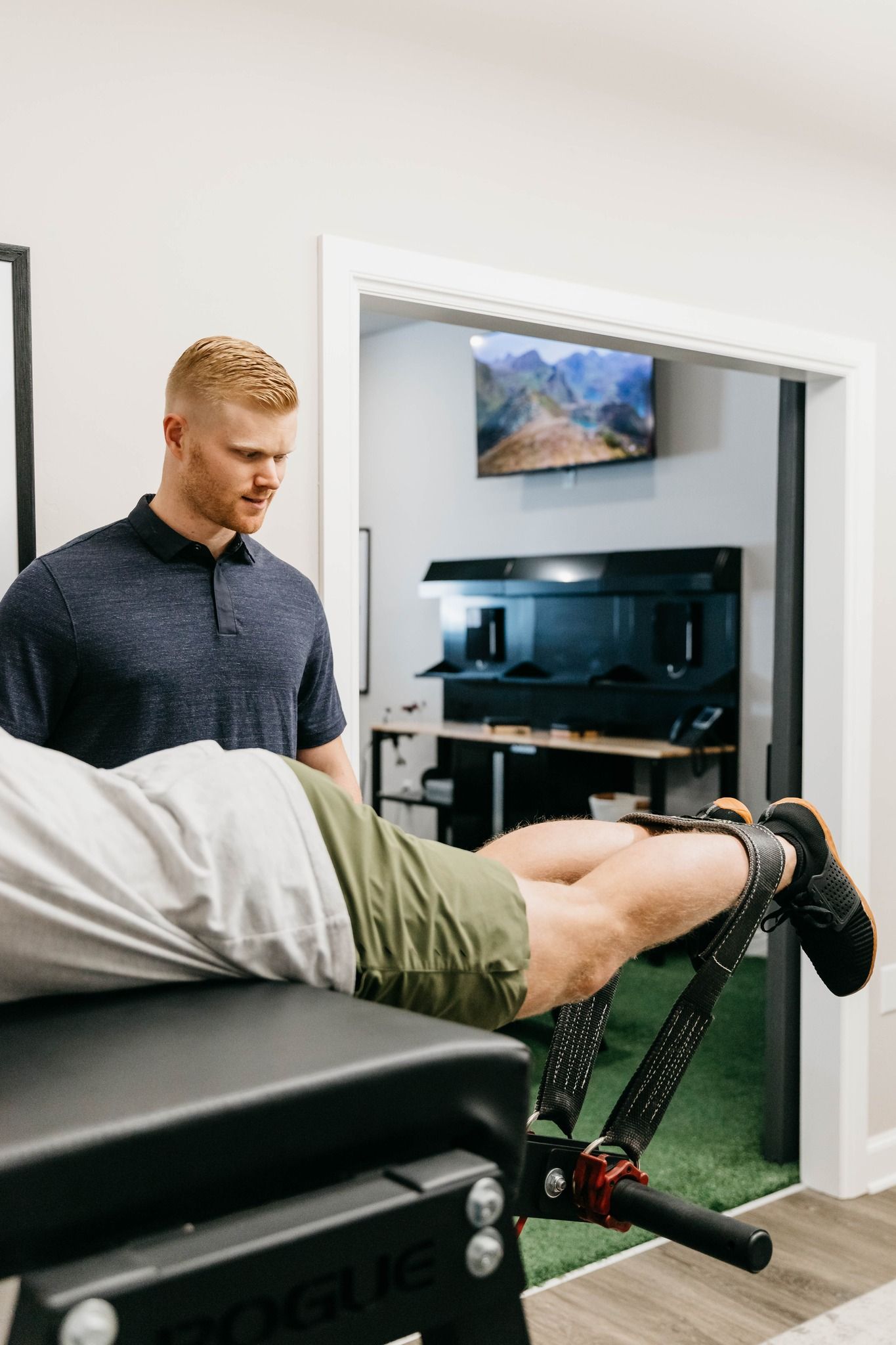 Physical therapist working with a patient on a treatment table in a clinical room