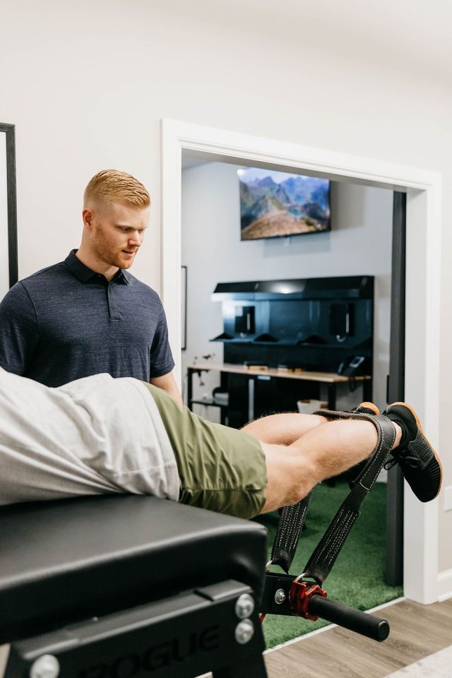 Physical therapist working with a patient on a treatment table in a clinical room