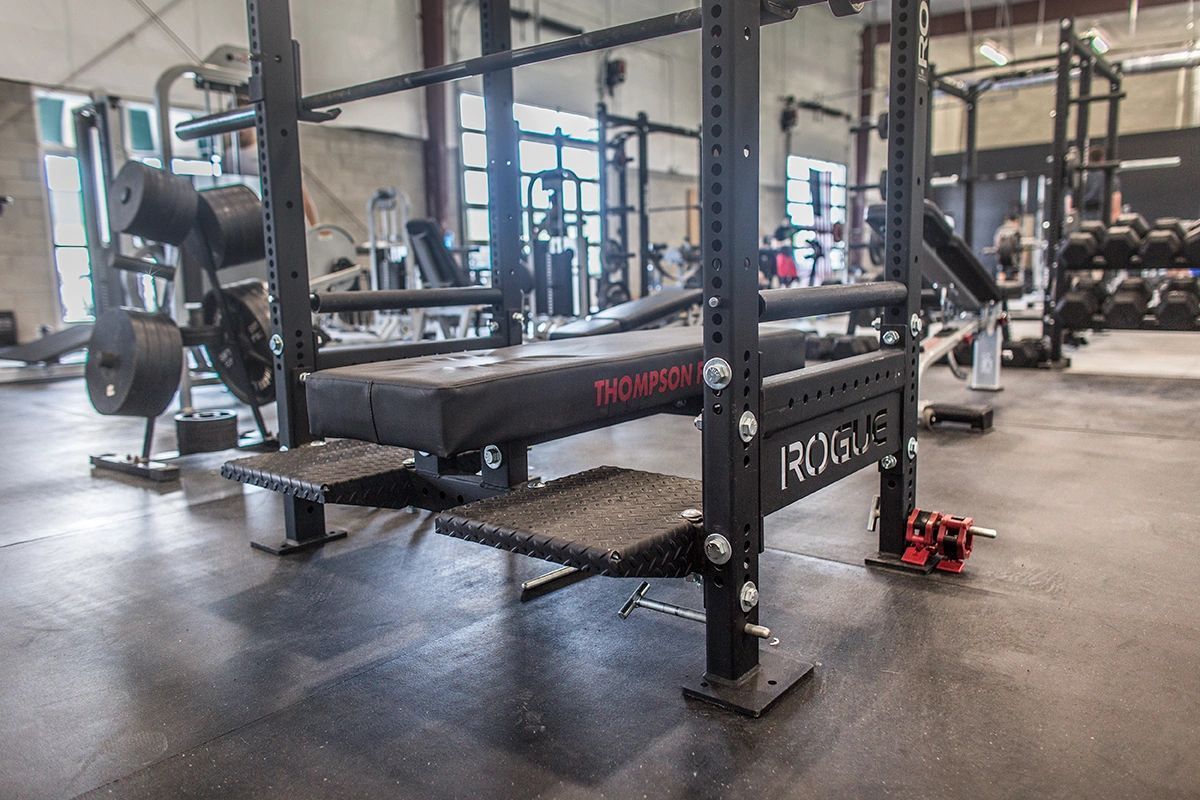 There is a bench in the middle of a gym.