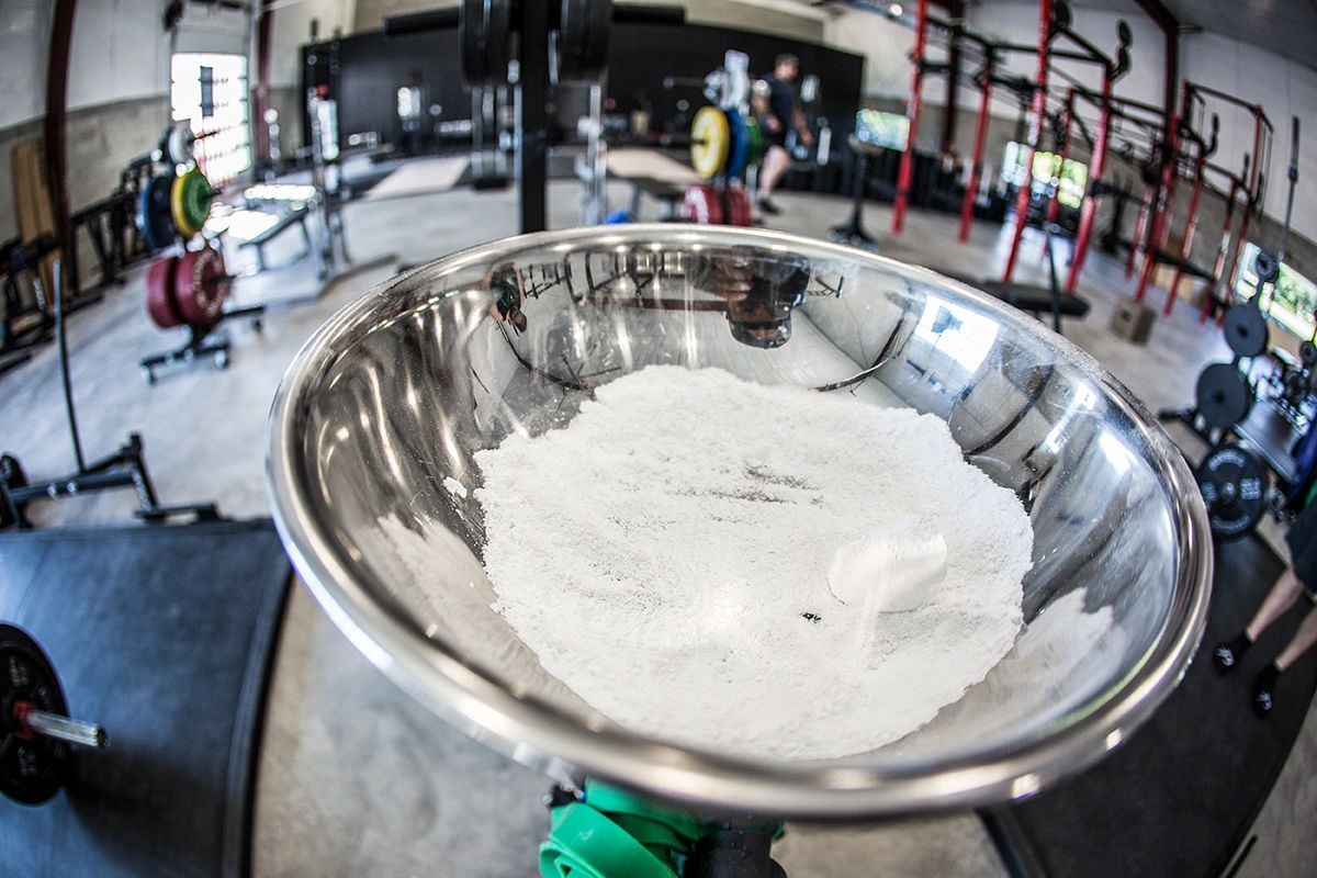 A metal bowl filled with white powder in a gym