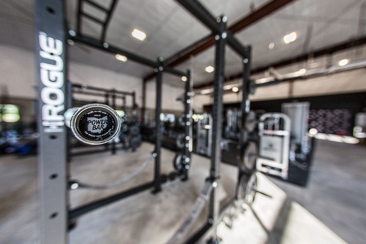 A gym with a rack that says rogue on it