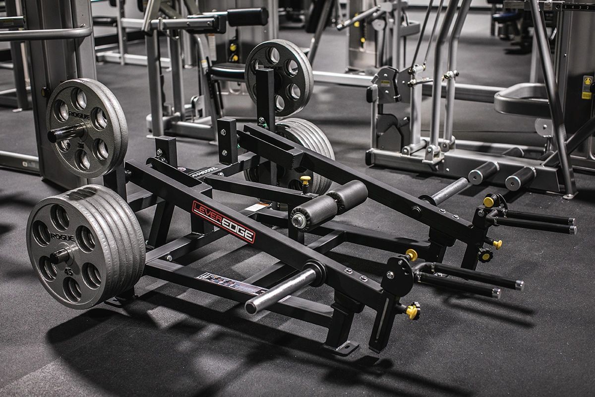 A gym with a lot of exercise equipment on the floor.