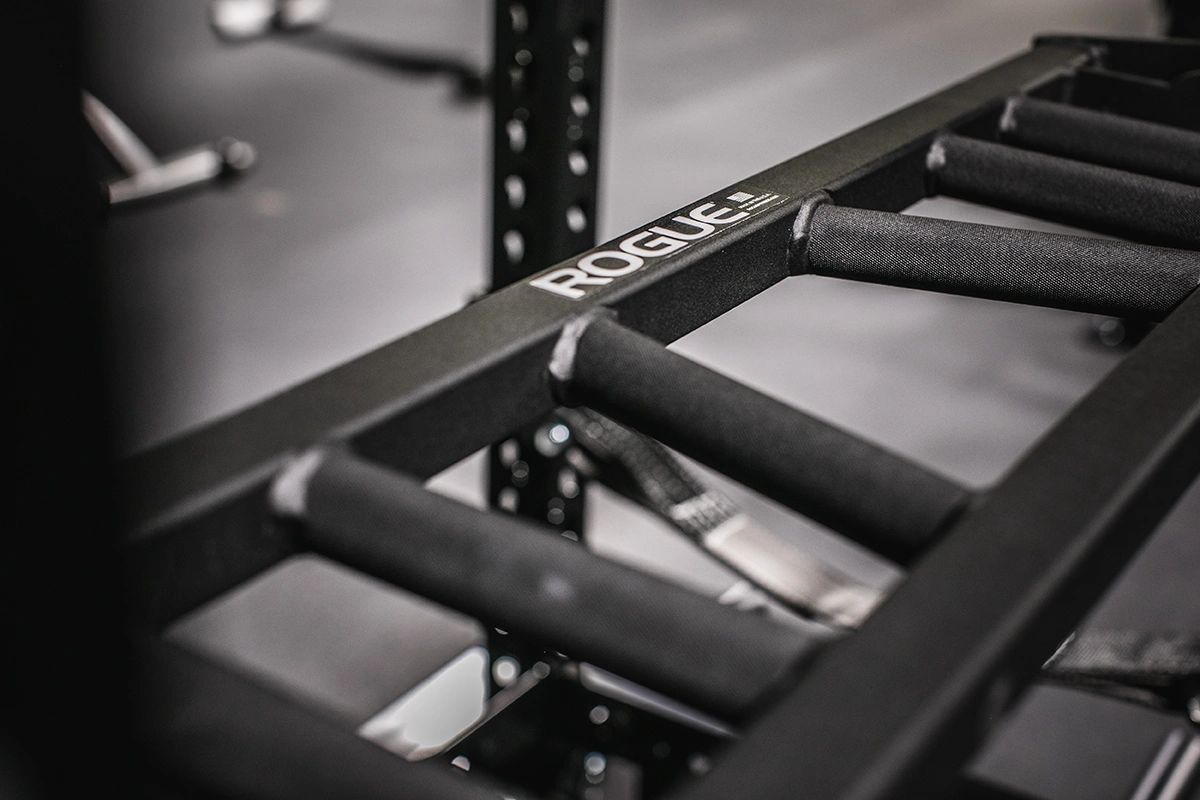 A close up of a rogue barbell rack in a gym.