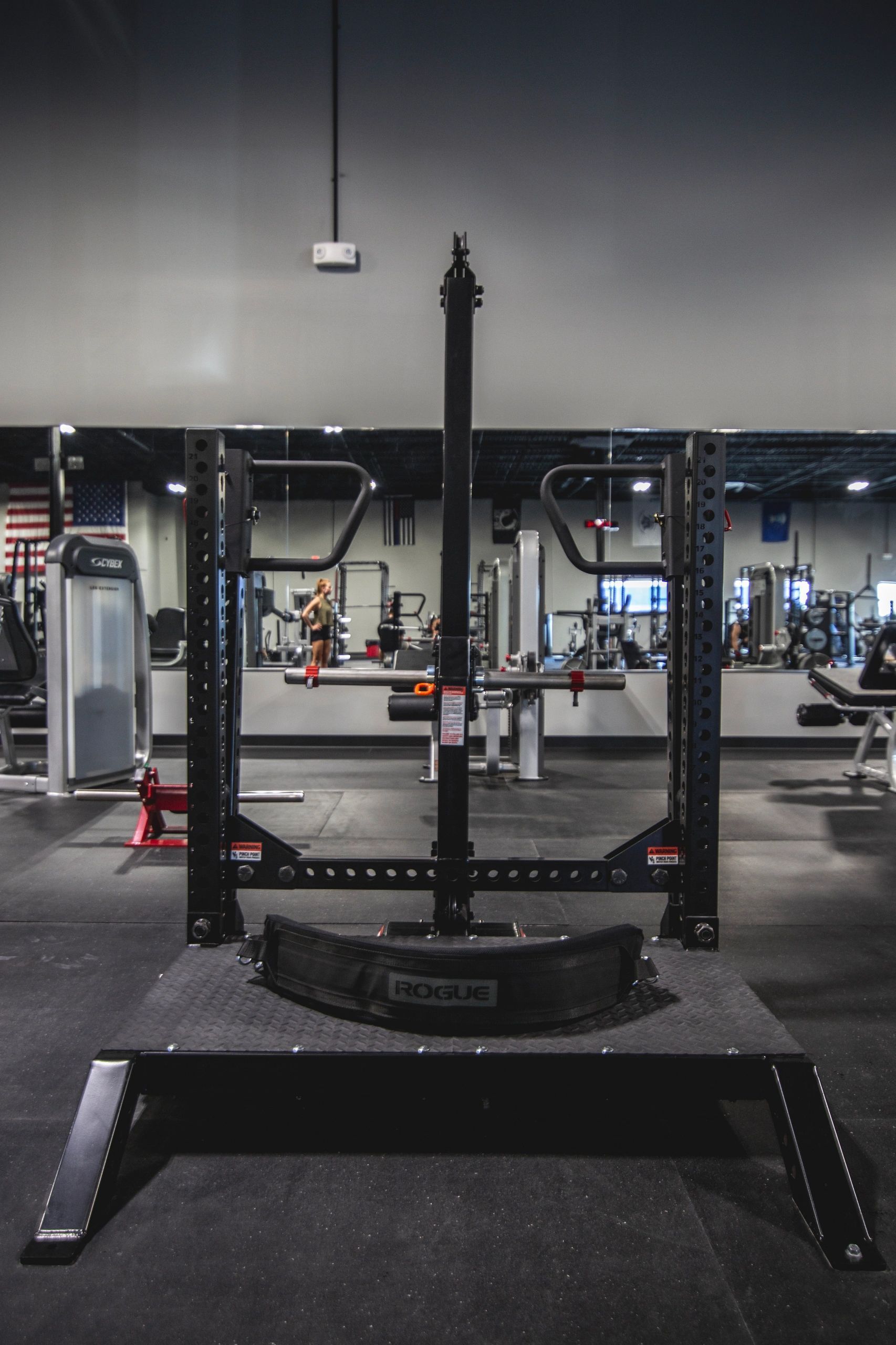 A gym with a squat rack in the middle