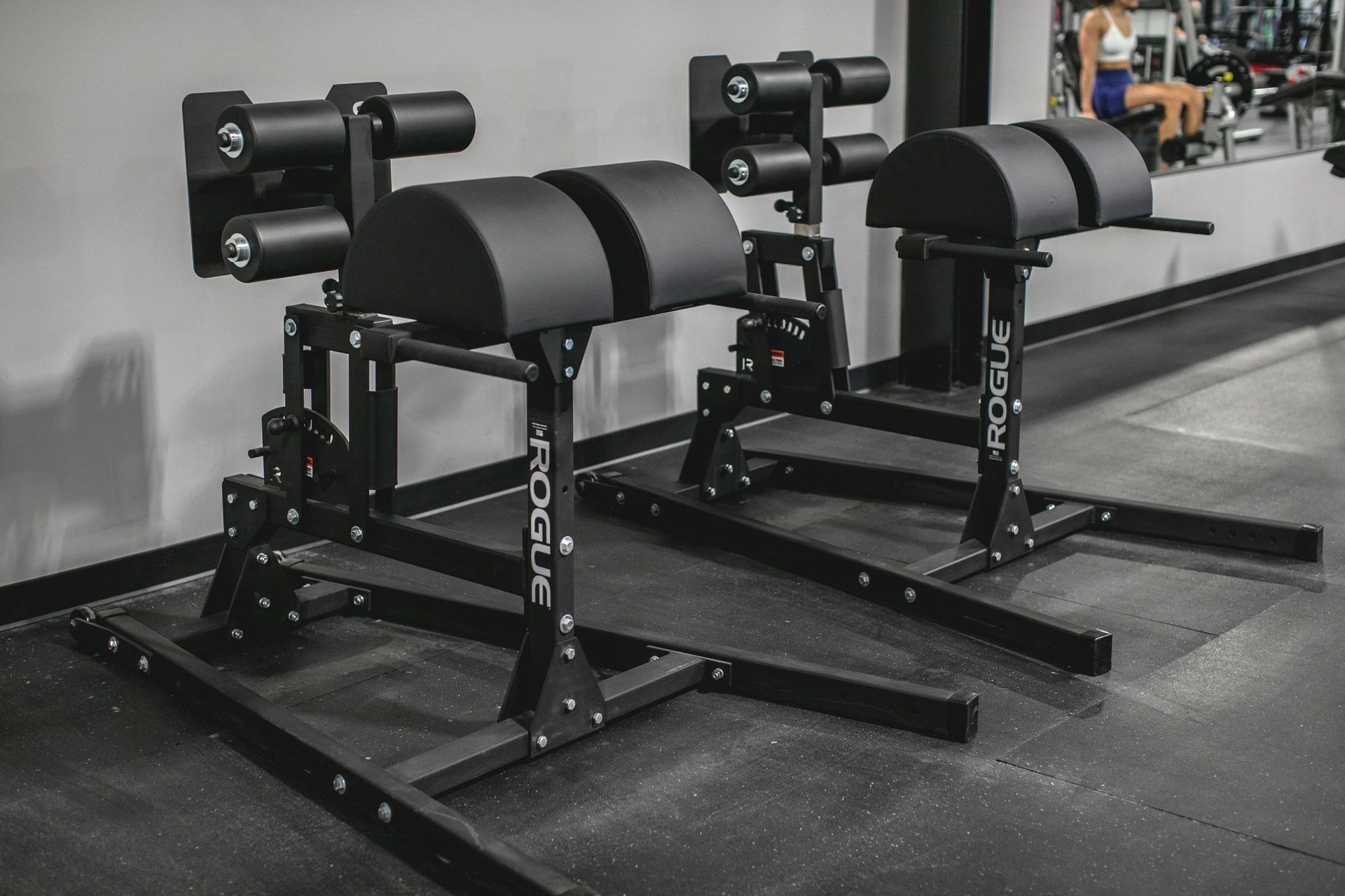Two rogue exercise machines are sitting next to each other in a gym.