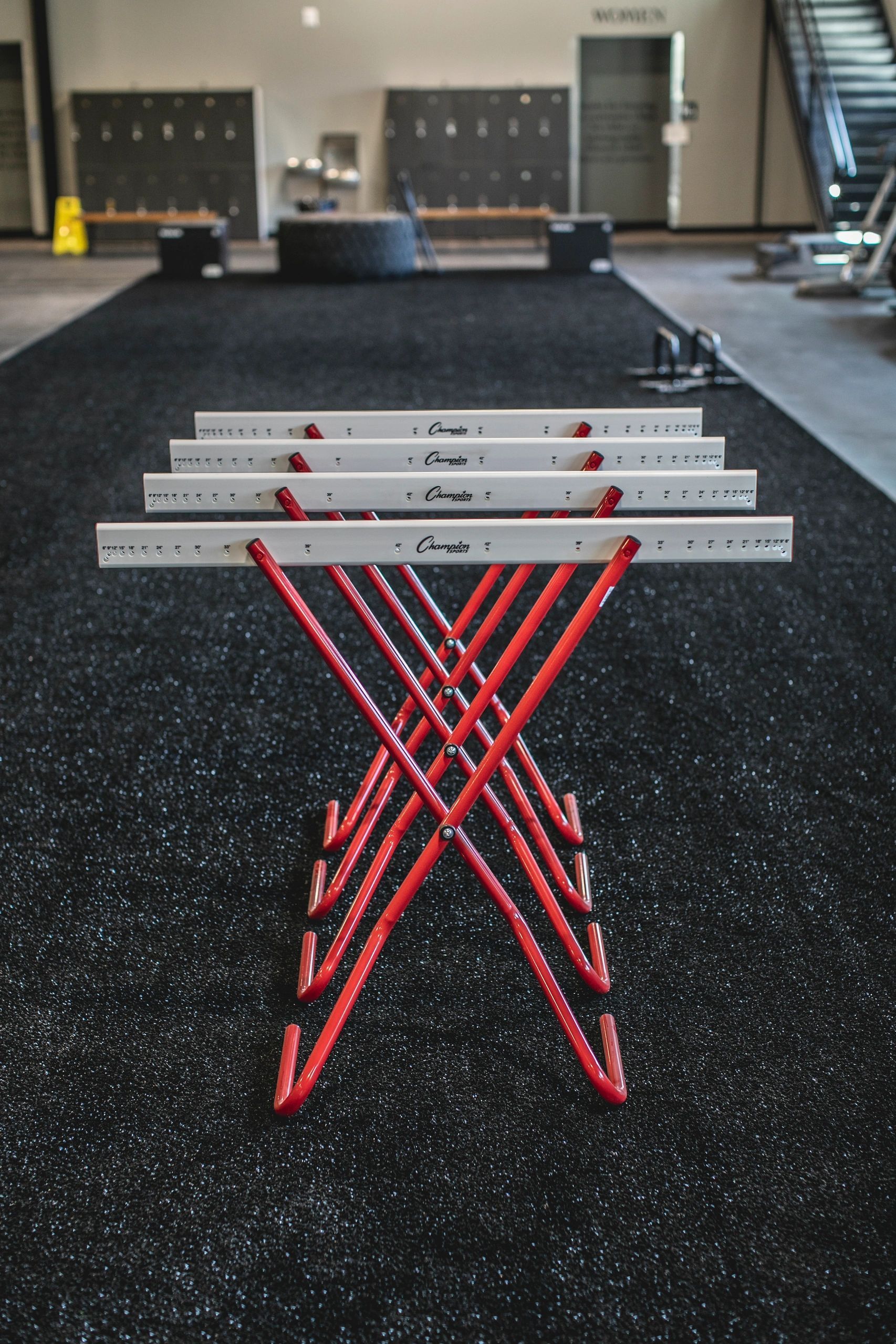 A row of hurdles are stacked on top of each other in a gym