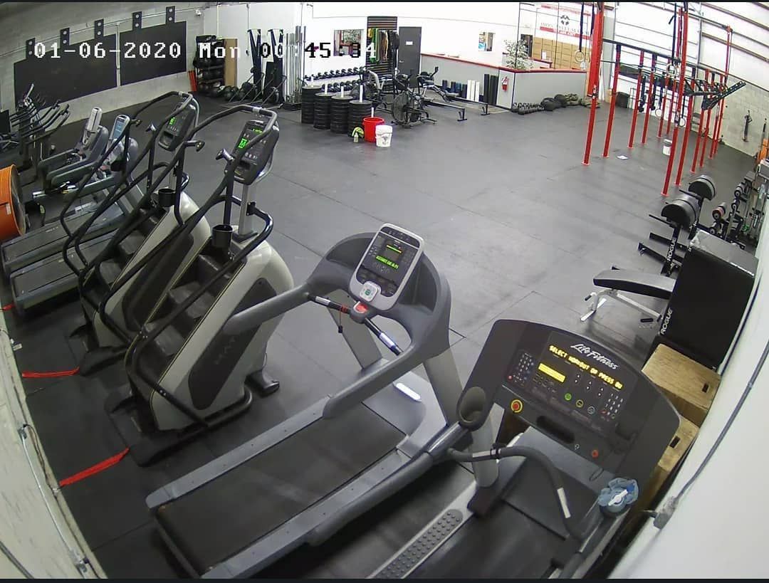 A gym with a lot of treadmills and stairs