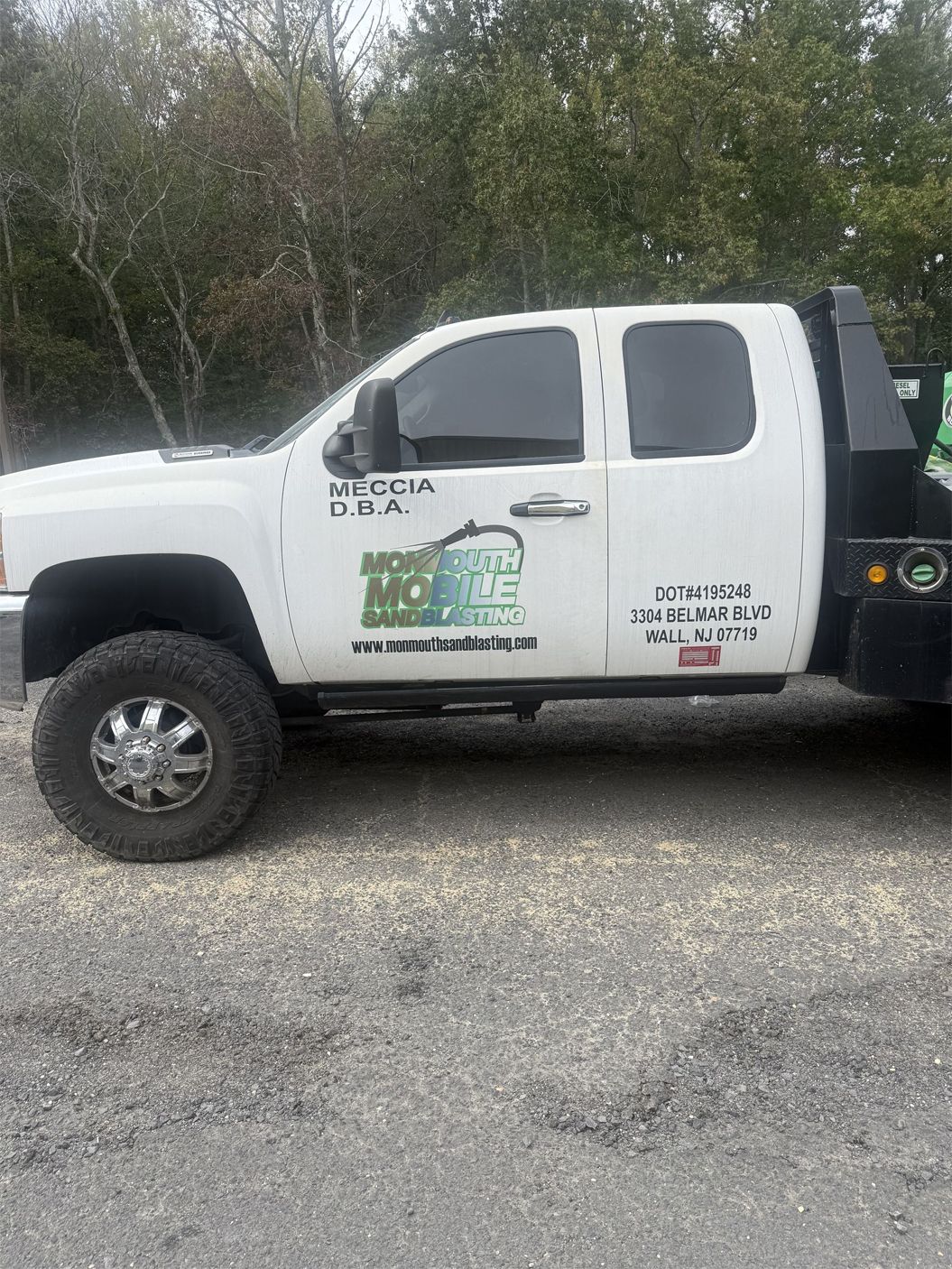 White pickup truck with green logo.