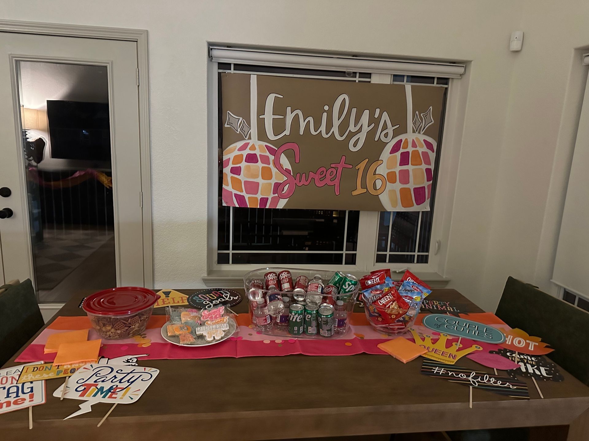 Sweet 16 party table with candy, decorations, and a banner reading