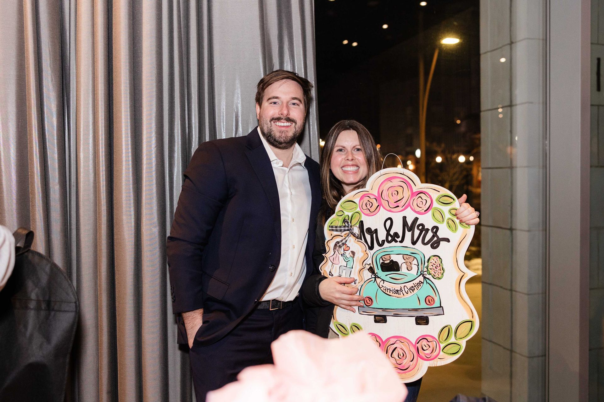 A smiling couple poses with a