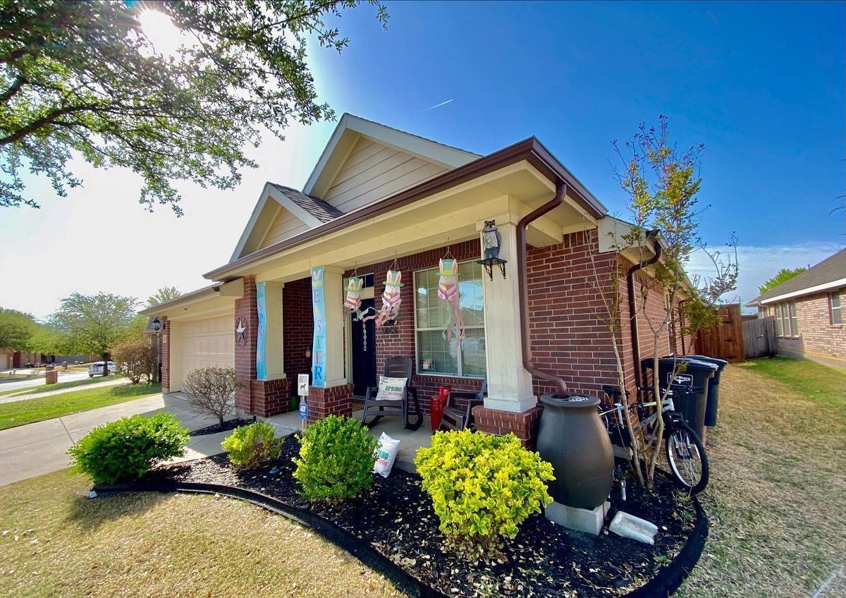 A brick house with a bicycle parked in front of it
