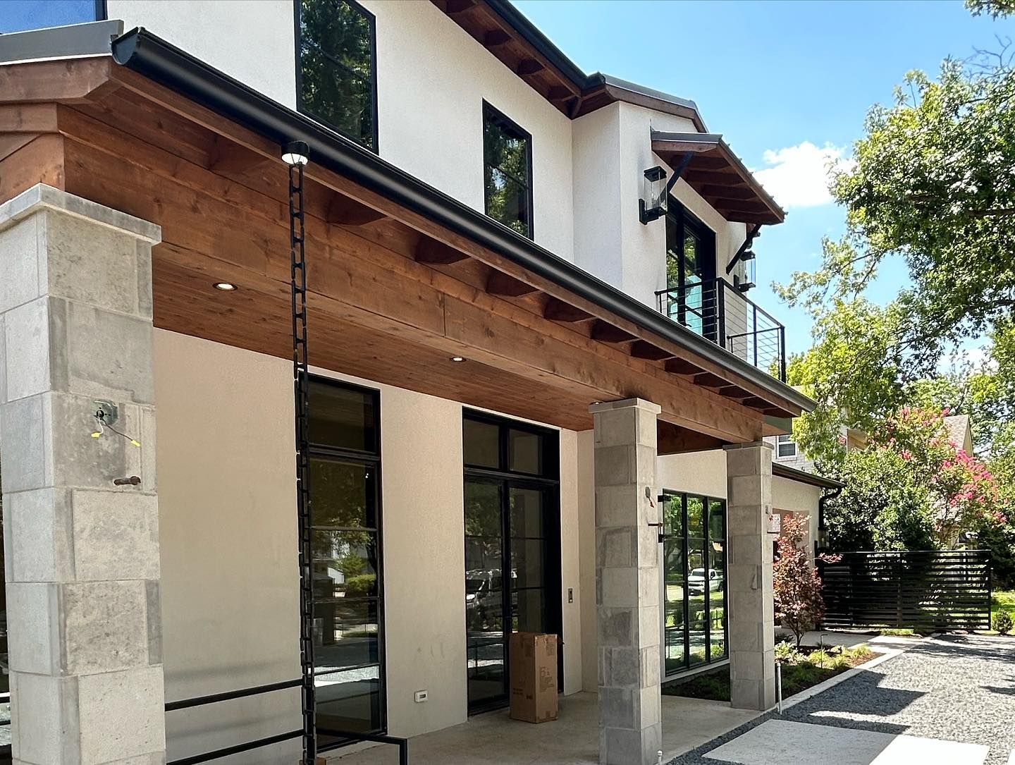 A large white house with a wooden roof and a lot of windows