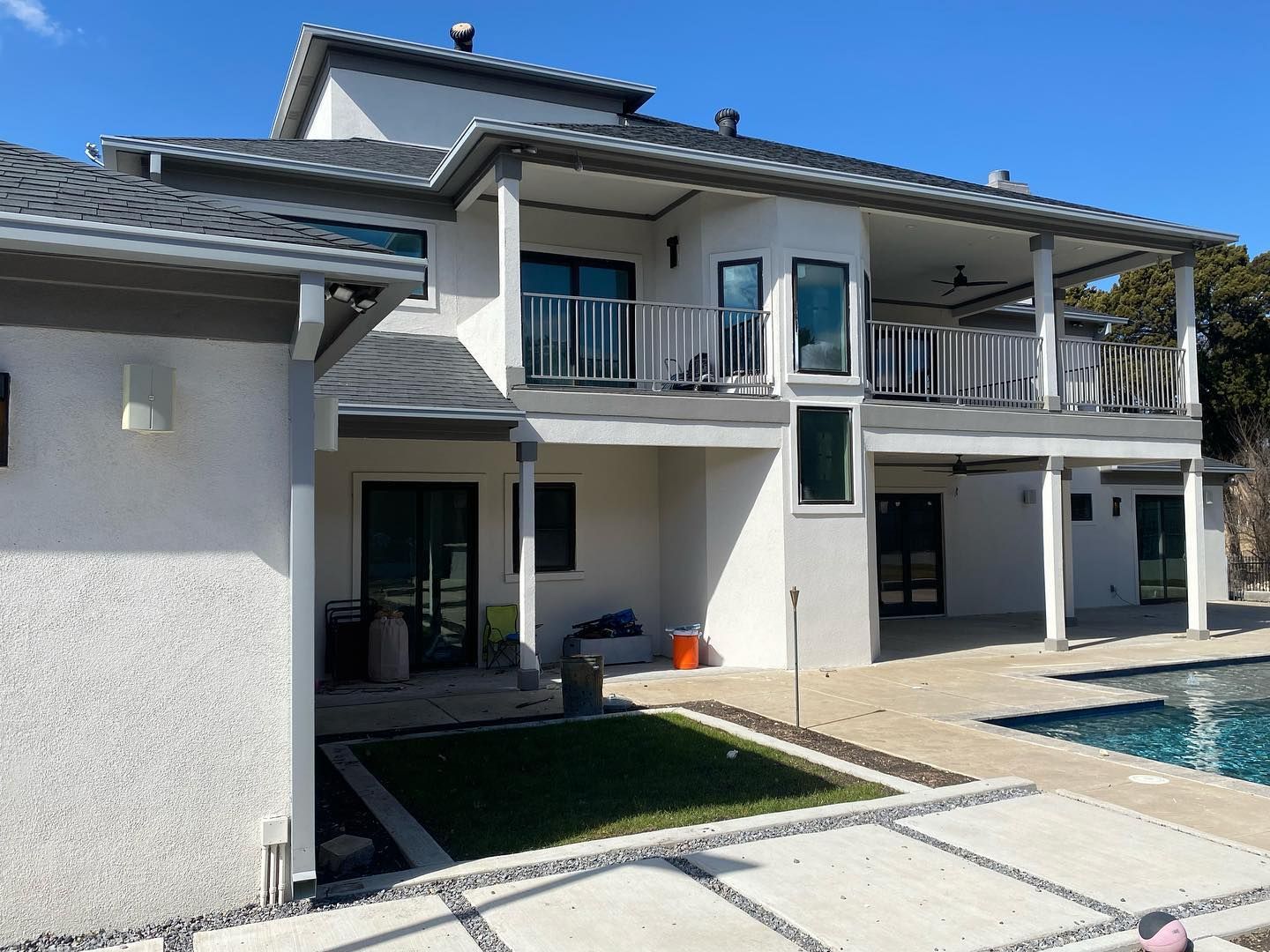 A large white house with a swimming pool in the backyard