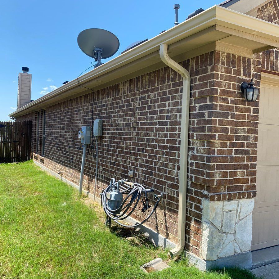 A brick house with a satellite dish on top of it