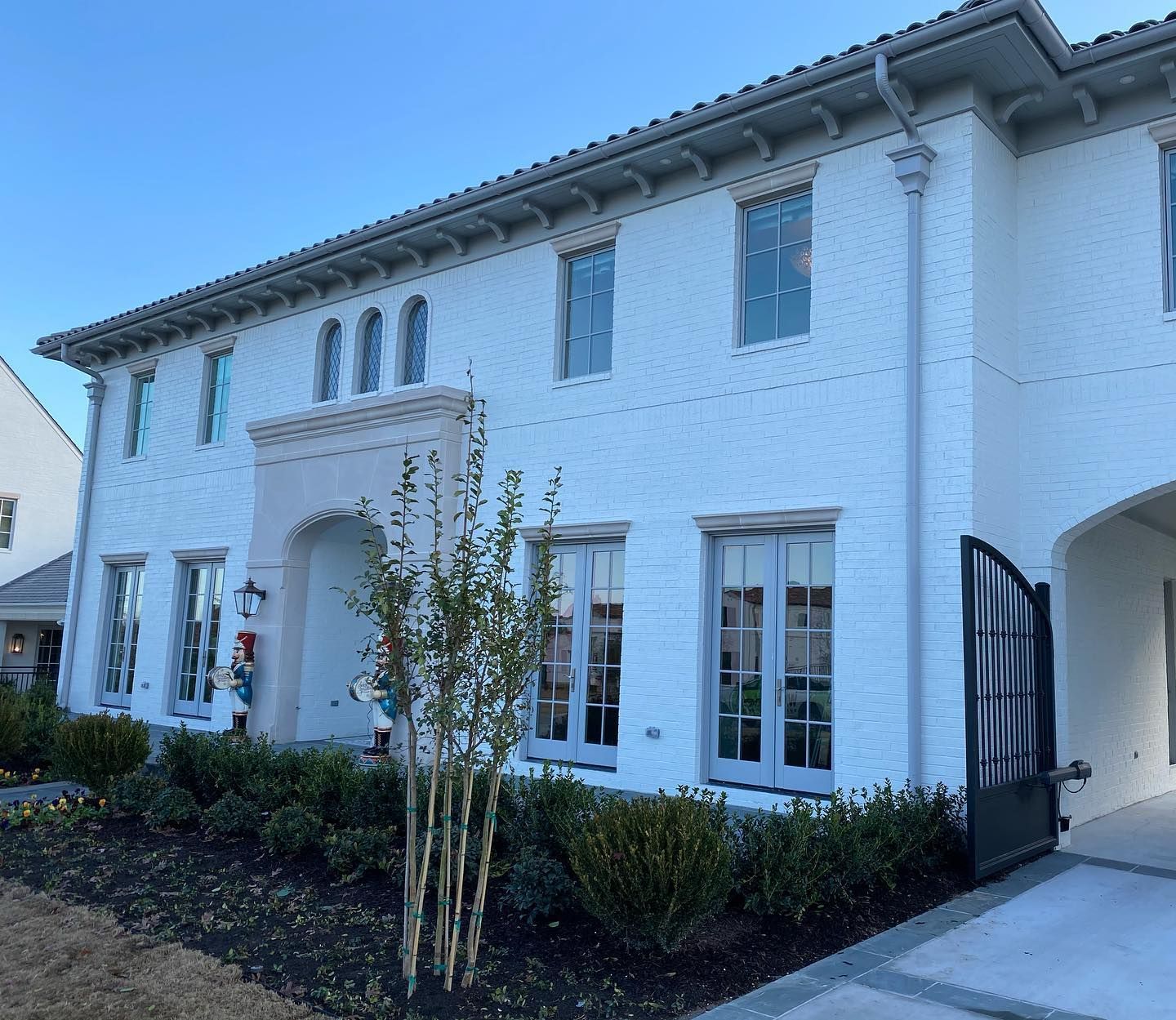 A large white brick house with a lot of windows