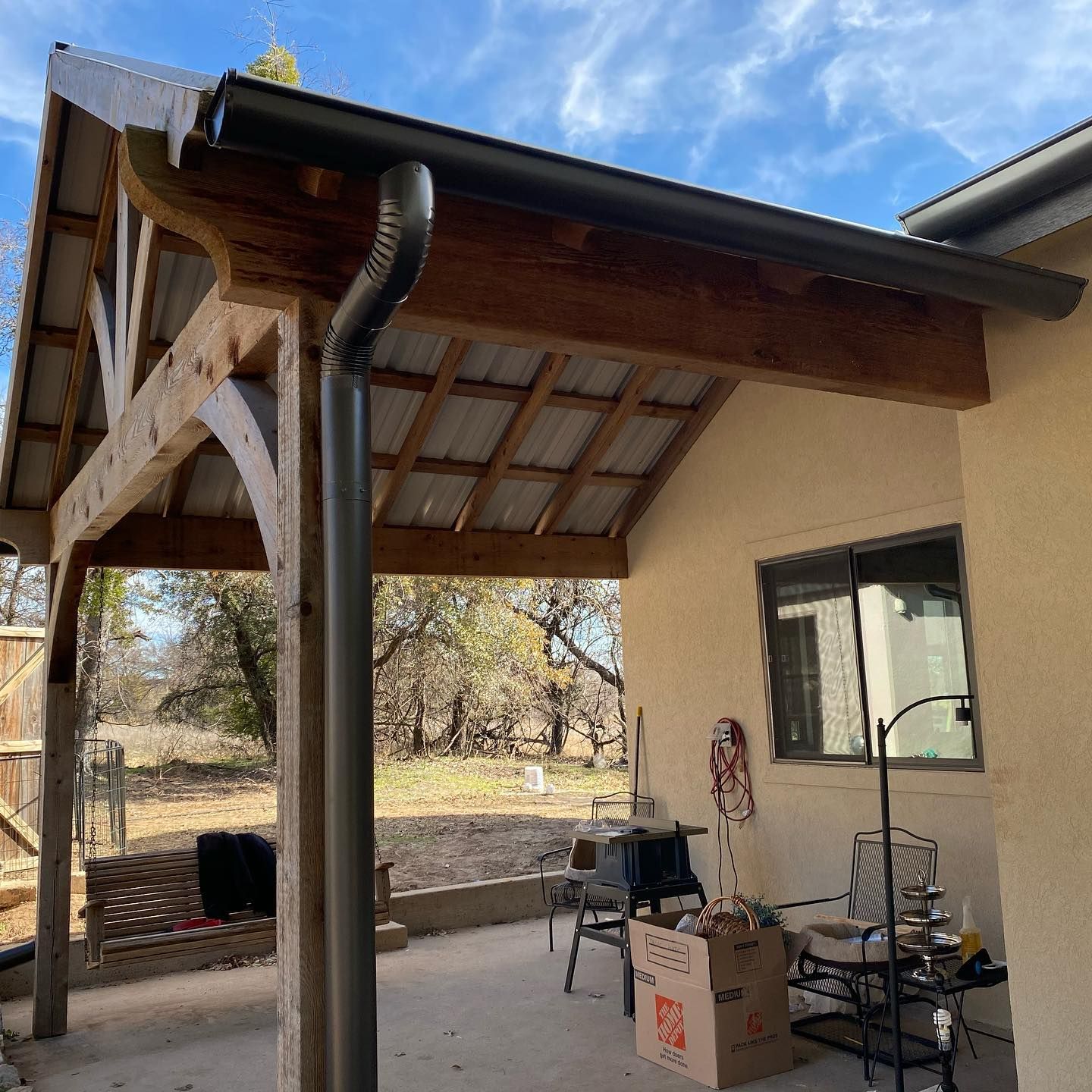 A house with a covered porch and a gutter on the roof