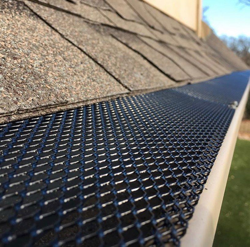 A close up of a gutter with a screen on it