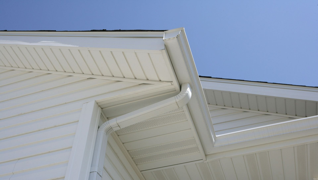 Gray tiled roof with a dark gutter and round exterior light beneath the eaves