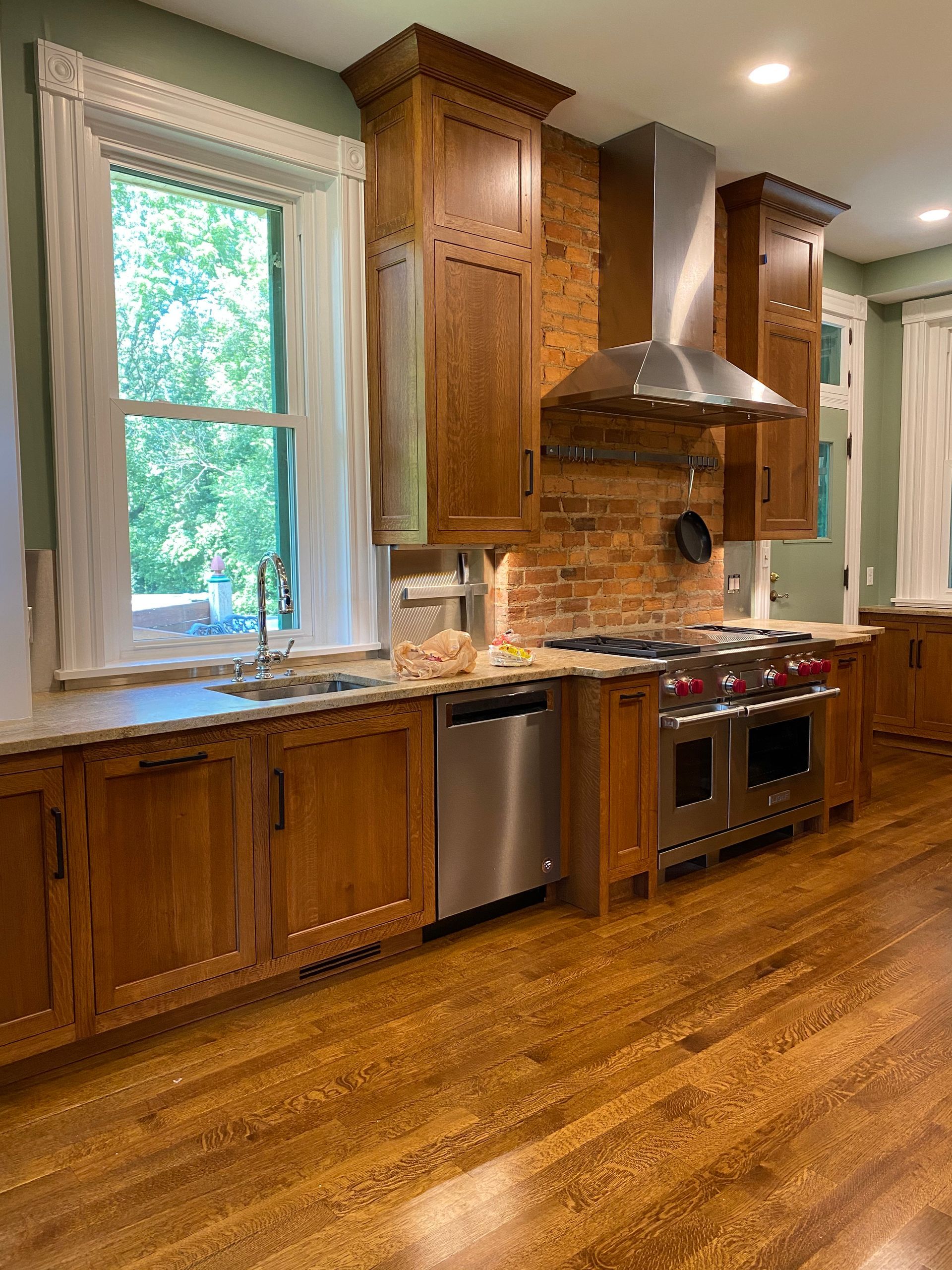 A kitchen with wooden cabinets and stainless steel appliances
