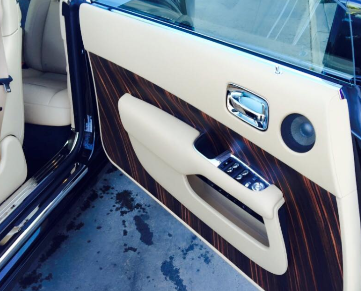The interior of a rolls royce car with the door open