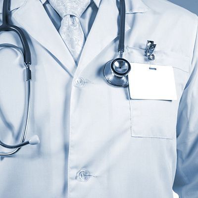 A close up of a doctor with a stethoscope around his neck