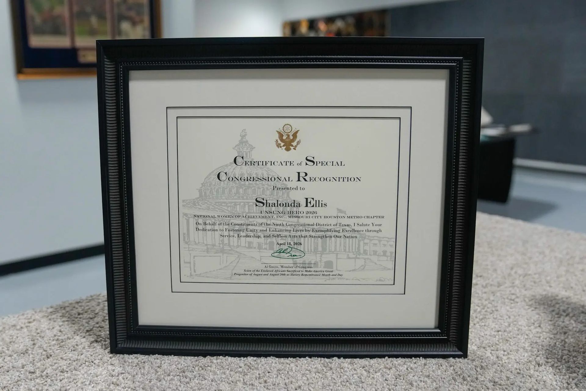 Framed certificate or award displayed on a speckled countertop