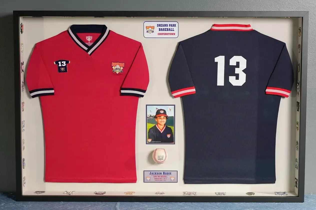 Framed sports memorabilia with red and navy jerseys, a portrait, and a large number 13 badge.