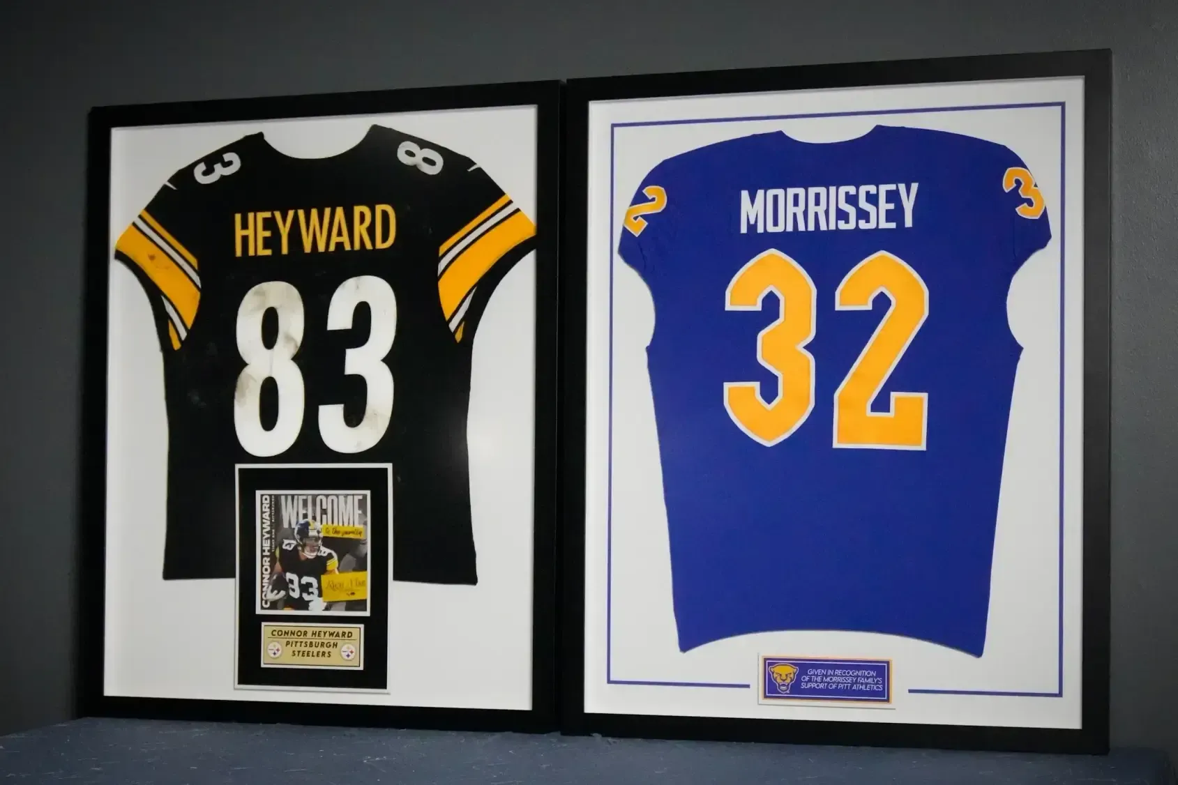 Framed black and blue sports jerseys with Heyward 83 and Morrissey 32, displayed side by side.