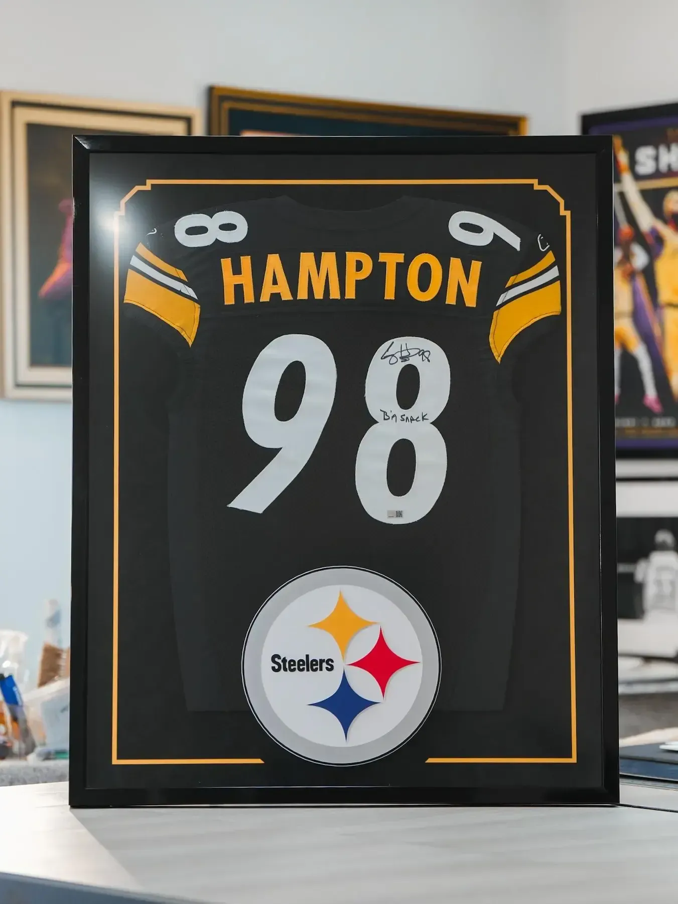 Black framed Steelers jersey plaque reading “HAMPTON” and “98” with Steelers logo