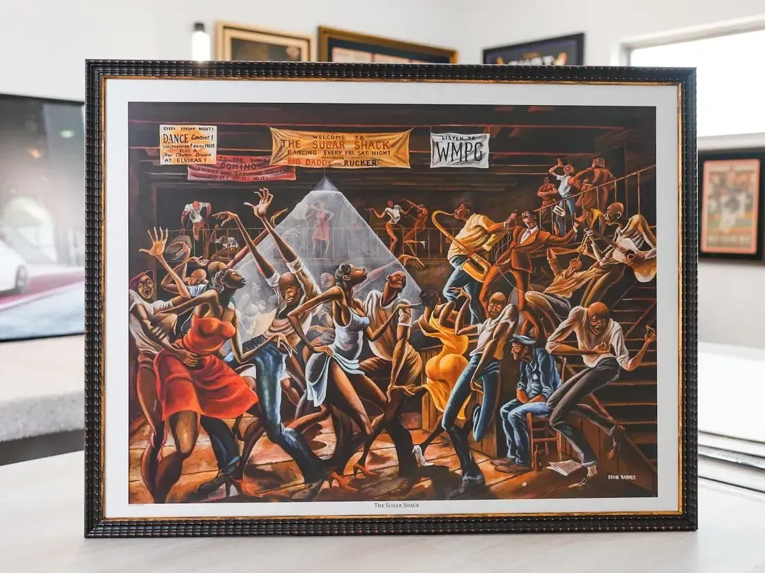 Framed painting of a chaotic sword battle with soldiers in red and blue uniforms, set on a tabletop.