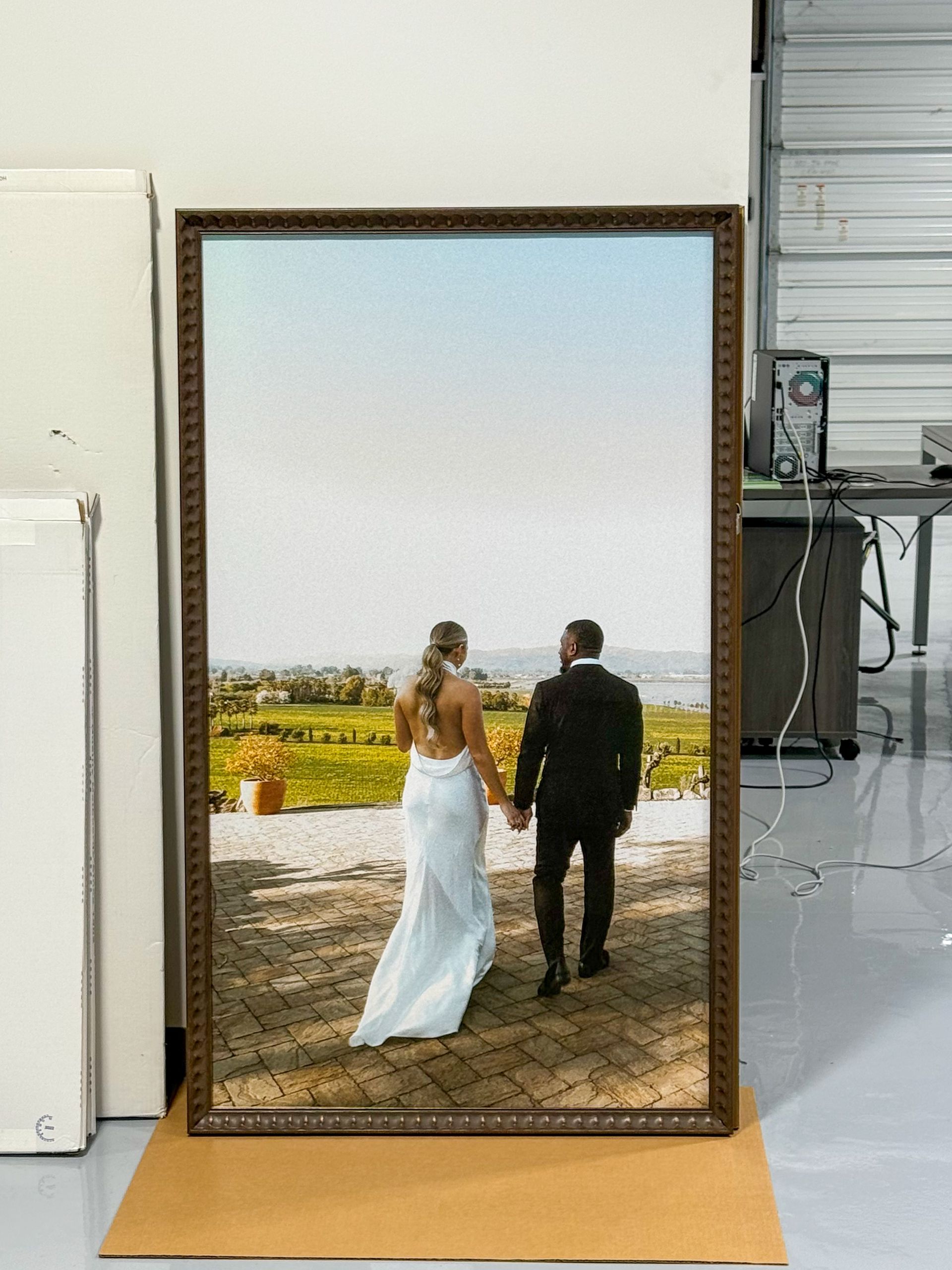 Framed photo of a couple walking hand in hand on a path overlooking a landscape