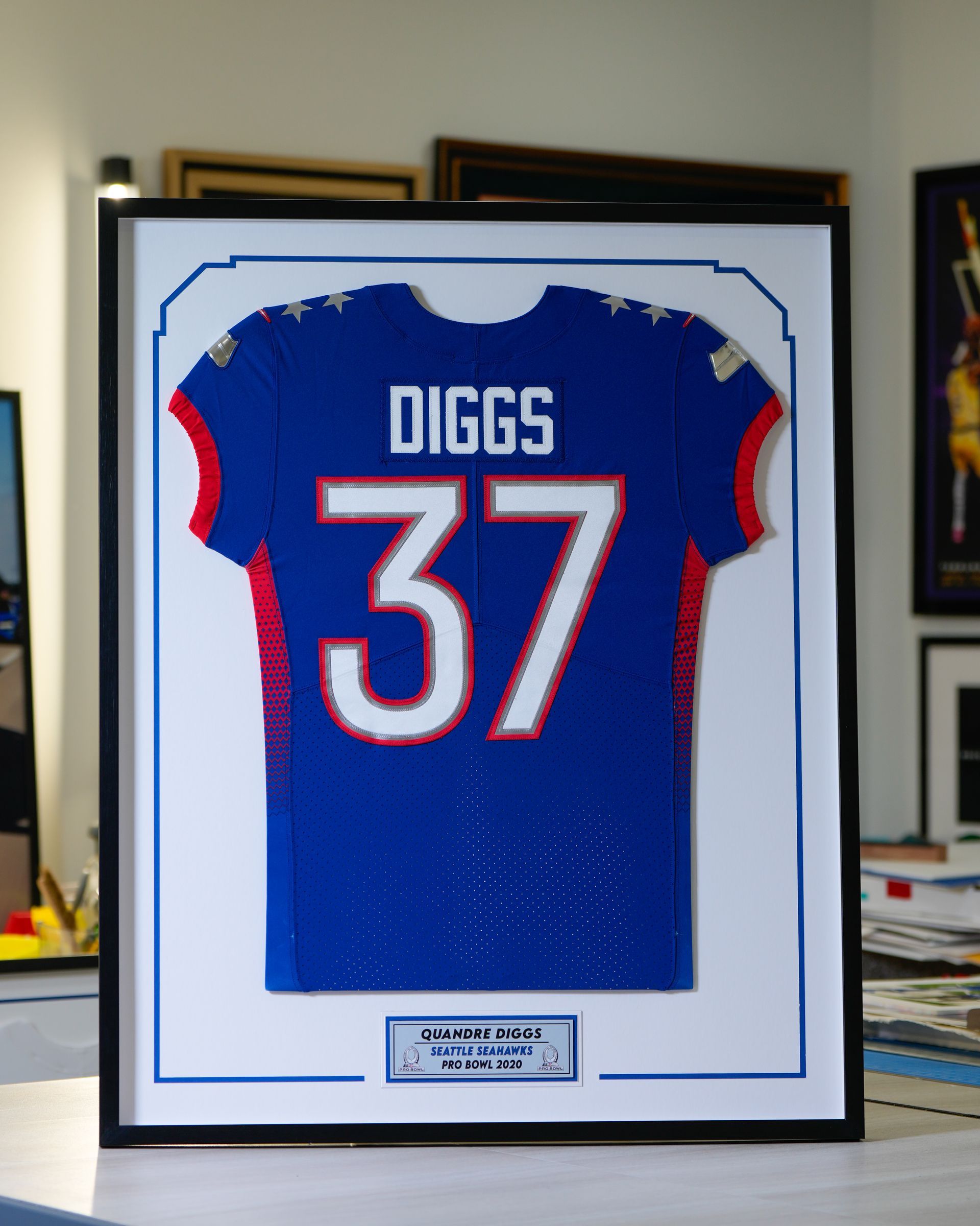 Framed blue Buffalo Bills jersey with “DIGGS” and number 37 on display