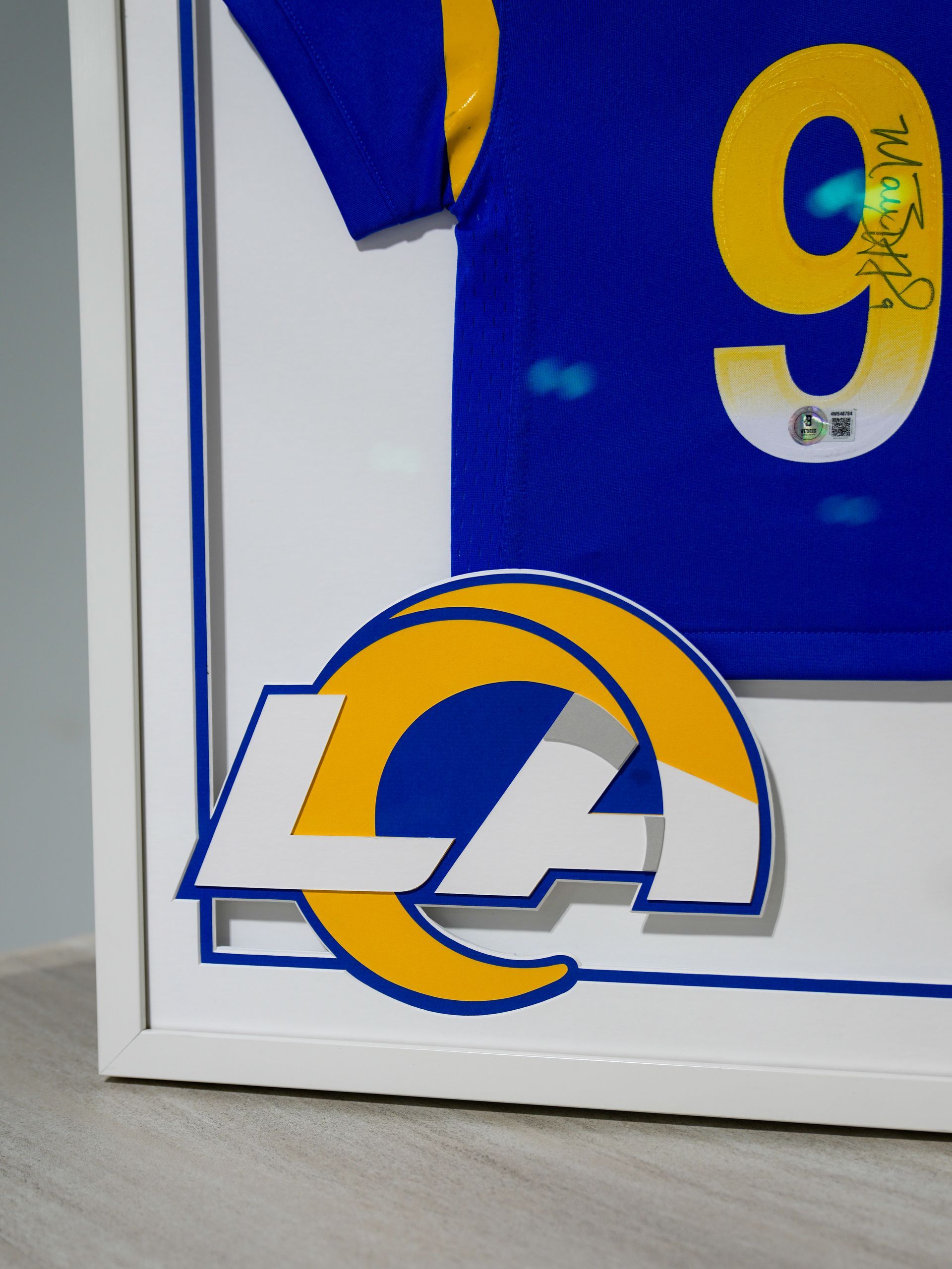 Blue and yellow sports jersey with a large number 9 and LA logo on the corner