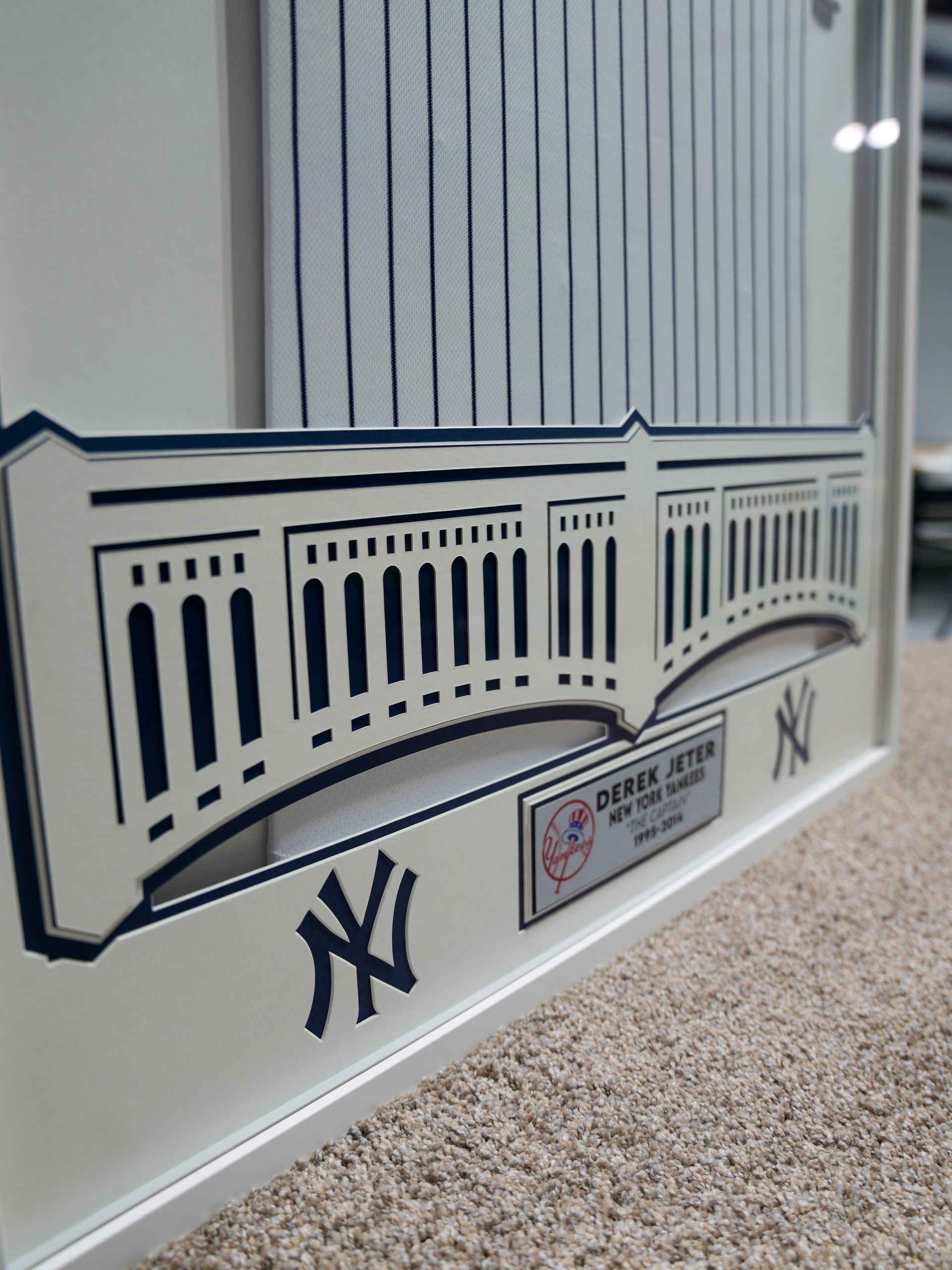 New York Yankees wall decal with stadium facade above carpeted floor and window blinds