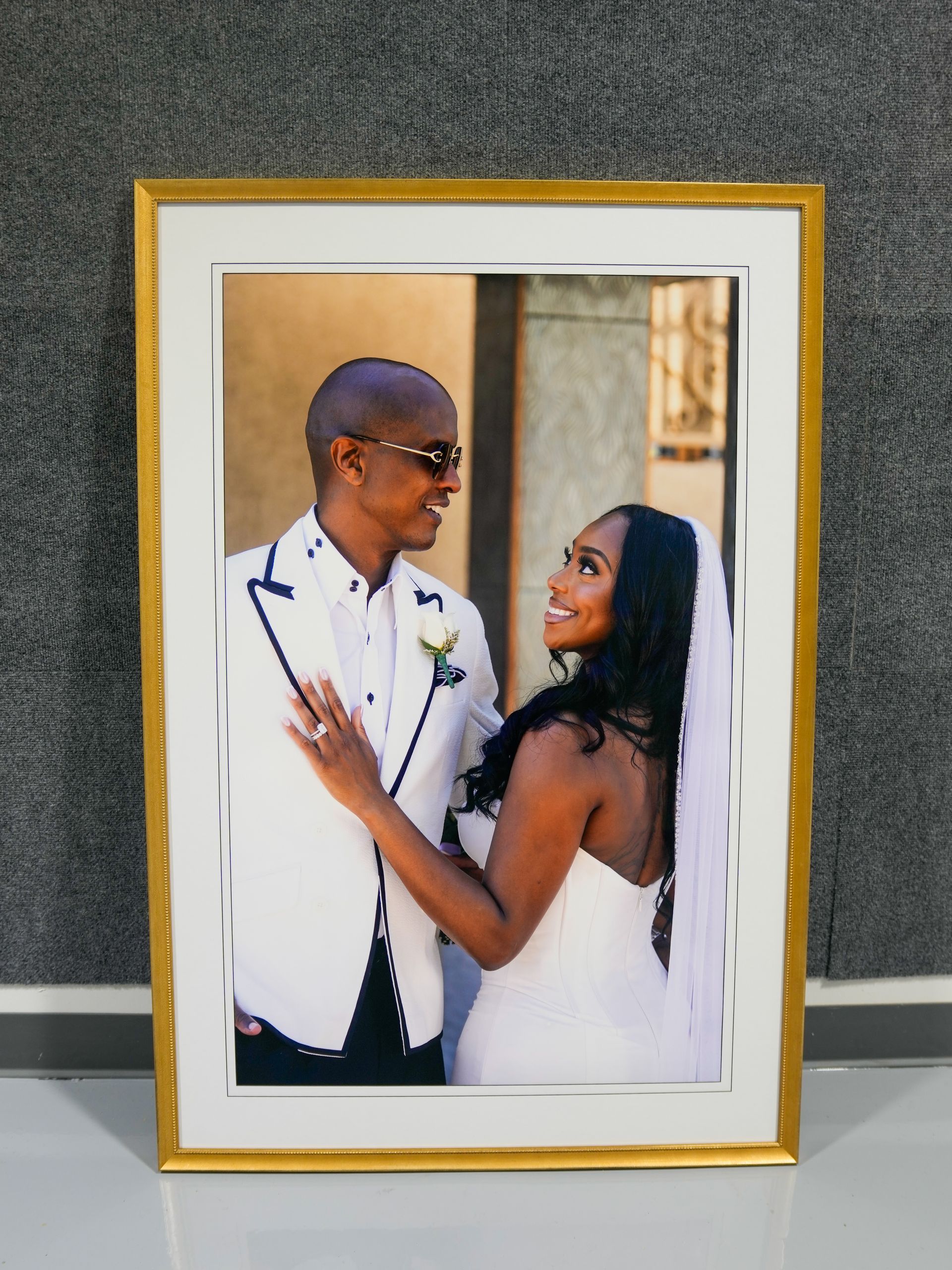 Framed wedding photo of a couple smiling at each other in formal attire