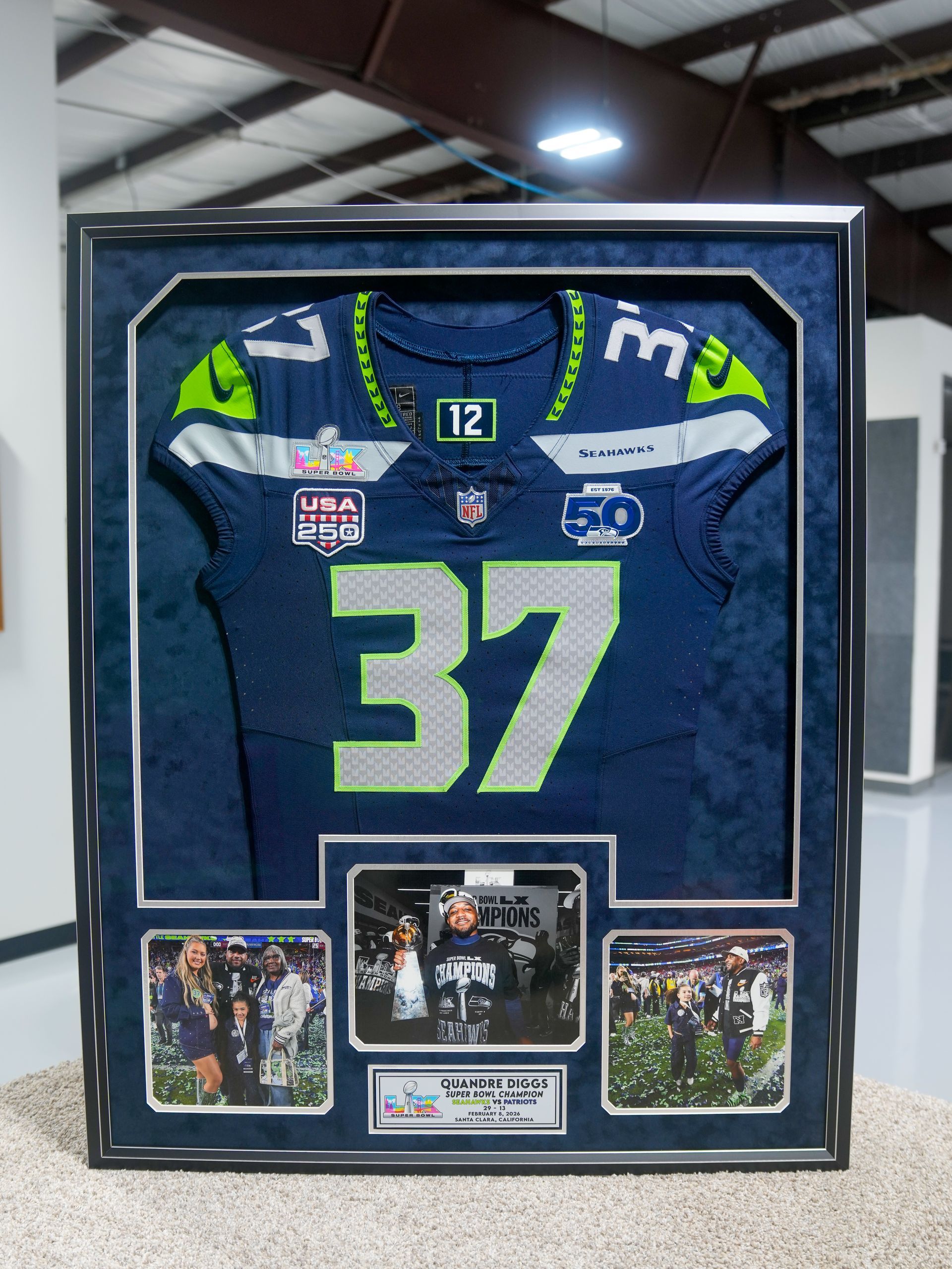 Framed blue Seattle Seahawks jersey with number 37 and three small game photos below
