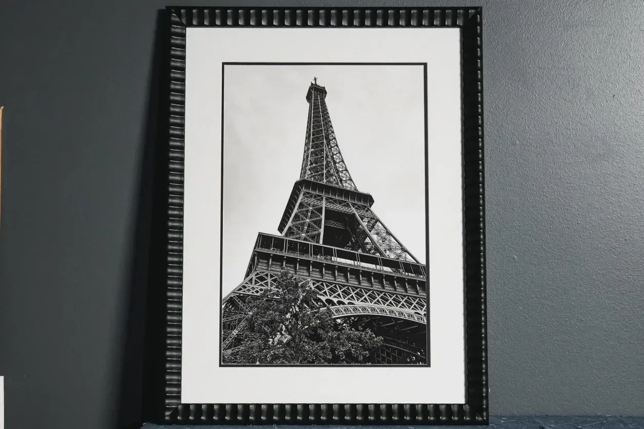 Framed black-and-white Eiffel Tower print on a wall