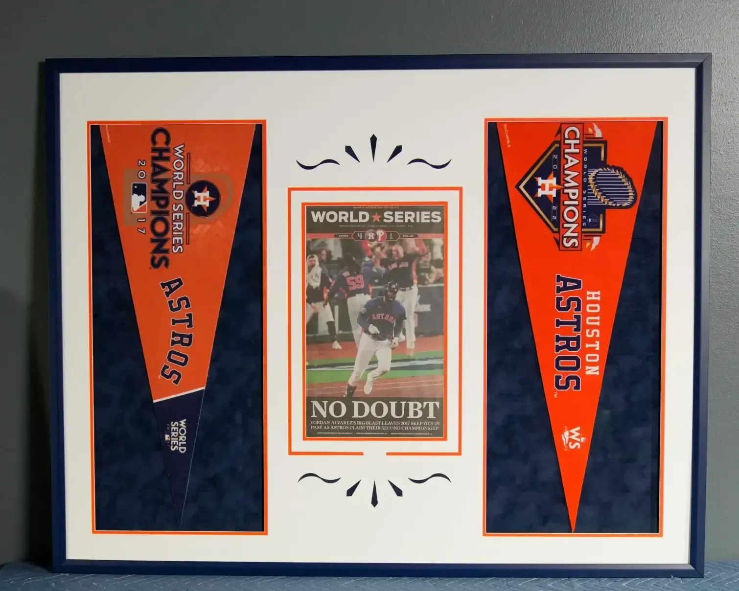 Framed Houston Astros World Series pennants with a central “No Doubt” baseball card display.