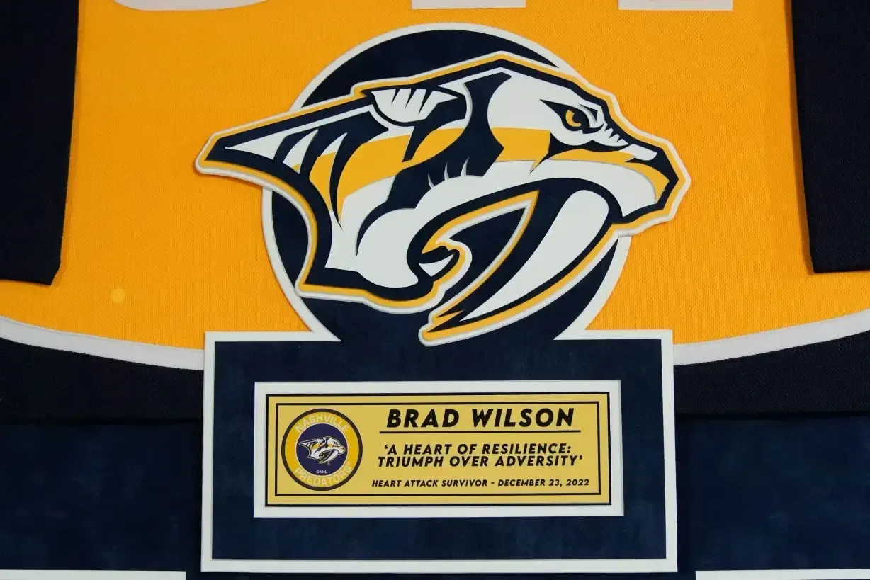 Nashville Predators logo above a Brad Wilson nameplate on an orange and navy jersey background