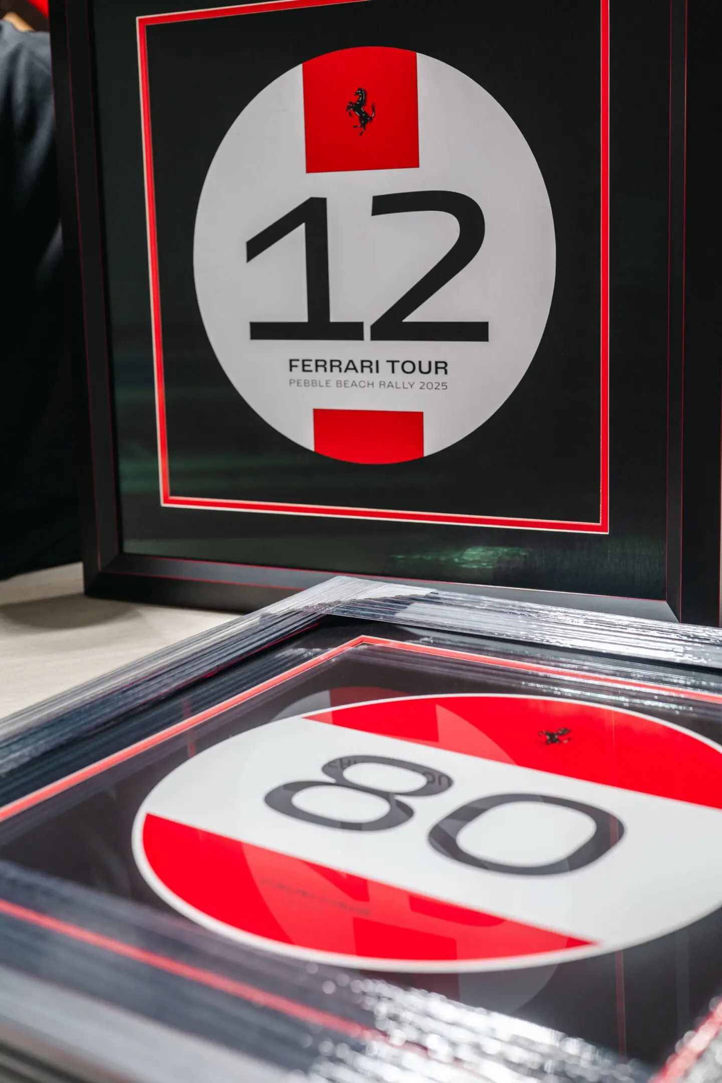 Two circular display panels with red-and-white graphics, showing numbers 12 and 80 on a dark surface.