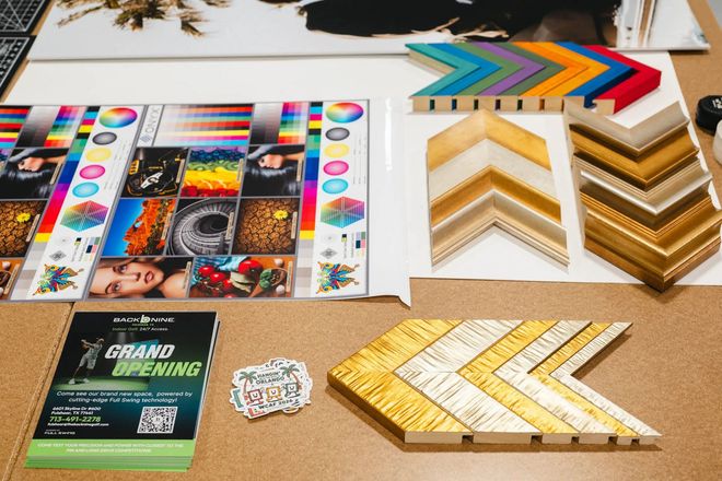 Assorted colorful patterned paper and gold chevron frames displayed on a tabletop