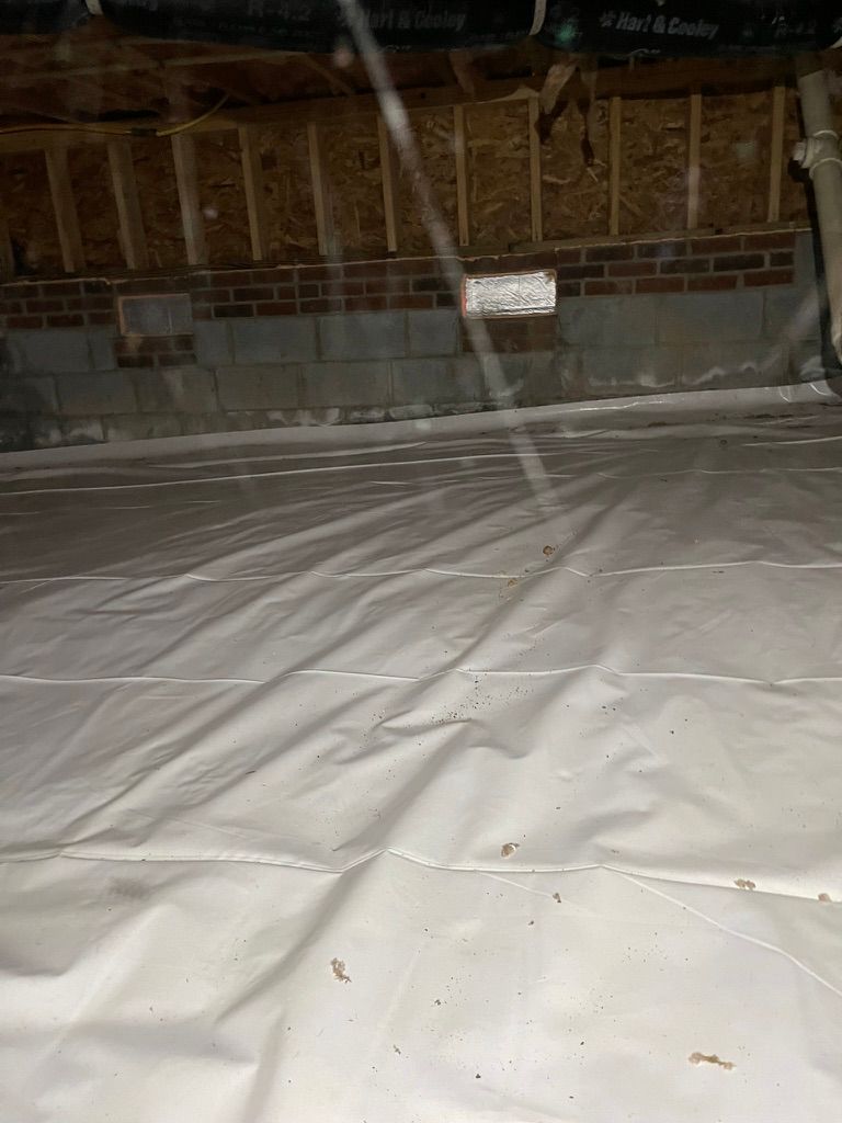 A large white tarp is covering the floor of a building.