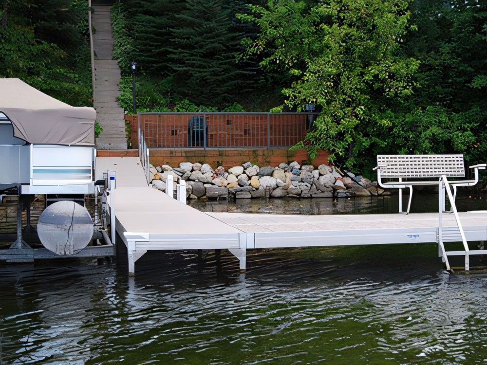 A boat is docked at a dock with a canopy over it.