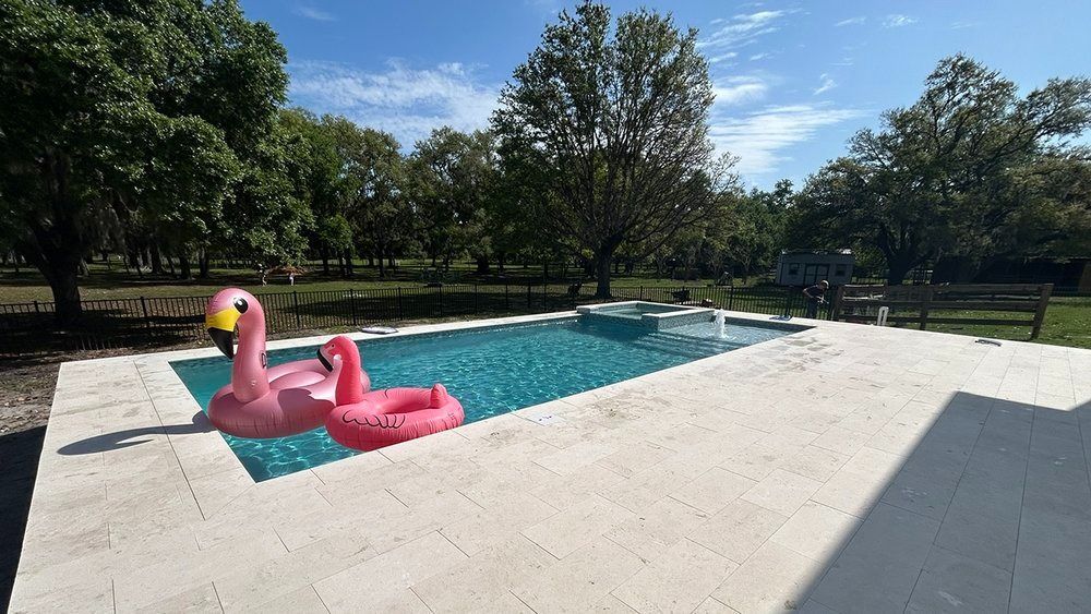 A pink flamingo float is floating in a swimming pool.