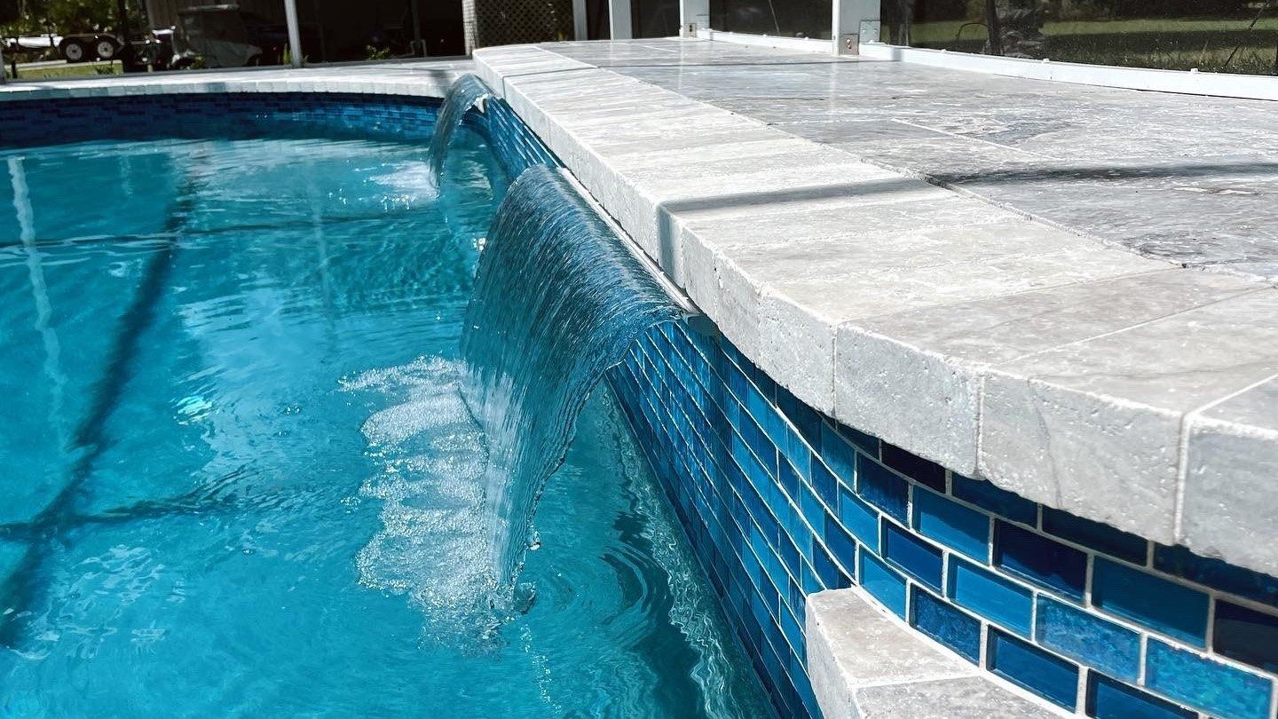 There is a waterfall in the middle of the pool.