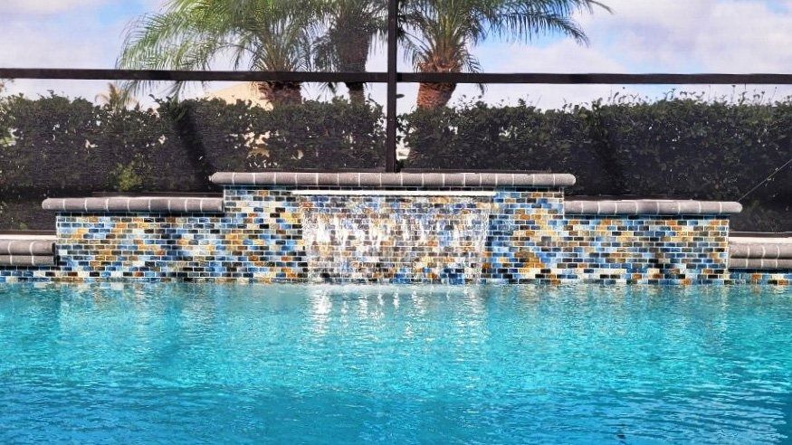 There is a waterfall in the middle of the pool.