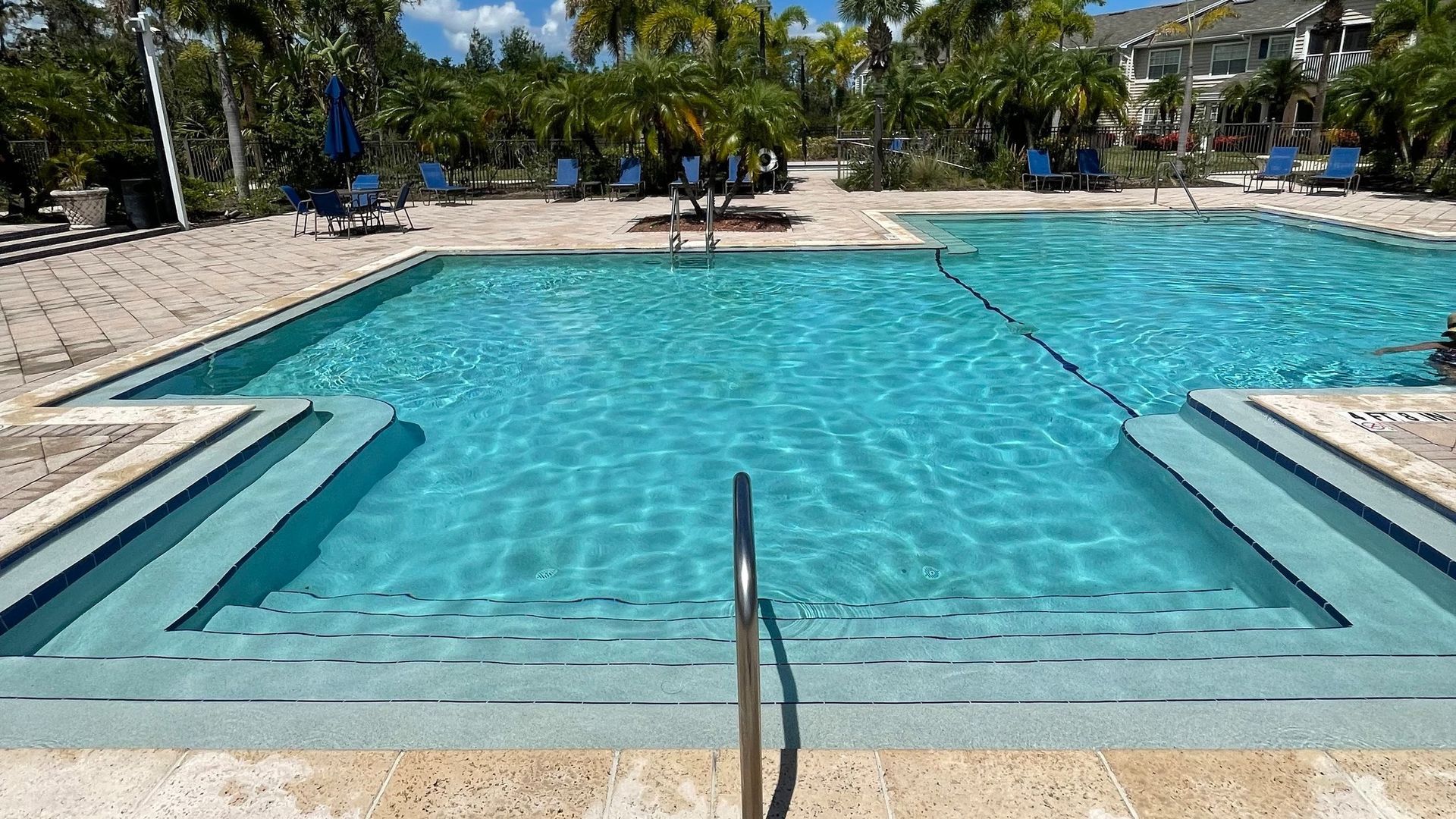 A large swimming pool with a staircase leading to it